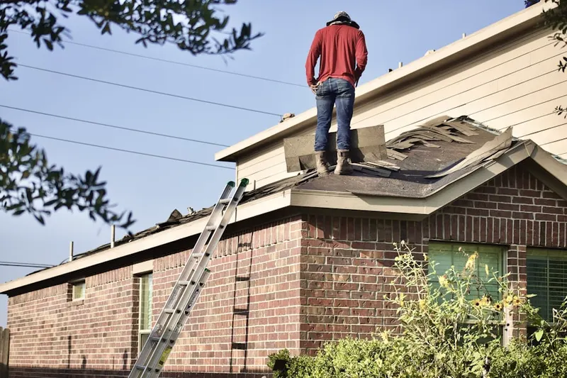 Professional roofer working on a residential roof in West Cocalico